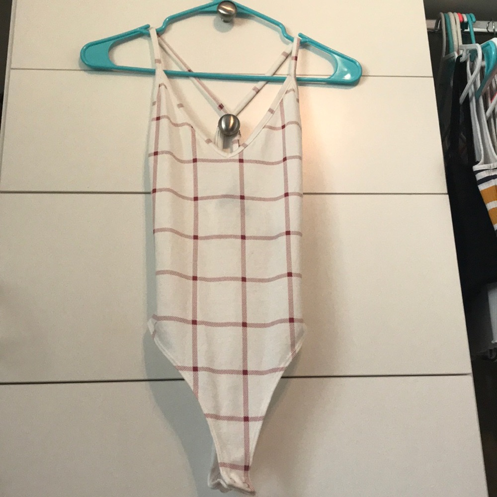 Cross back, low cut body suit